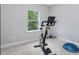 This gym area features a stationary bike and large window at 128 Chapel Run Way, Chapel Hill, NC 27517