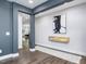 Hallway with dark wood floors, a floating shelf, modern art, and an open view into other rooms at 128 Chapel Run Way, Chapel Hill, NC 27517