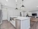Modern kitchen with stainless steel appliances, island with sink, and open view to the living area at 128 Chapel Run Way, Chapel Hill, NC 27517