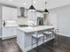 Stylish kitchen with a large island, stainless steel appliances, and sleek white cabinetry at 128 Chapel Run Way, Chapel Hill, NC 27517