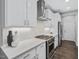 Modern kitchen featuring white countertops, stainless steel appliances, and sleek cabinetry at 128 Chapel Run Way, Chapel Hill, NC 27517