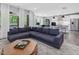 Spacious open-concept living room with a stylish sectional sofa and modern kitchen in the background at 128 Chapel Run Way, Chapel Hill, NC 27517