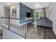 Upstairs loft featuring a comfortable seating area, large windows, and modern decor, perfect for relaxing at 128 Chapel Run Way, Chapel Hill, NC 27517