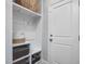 Mudroom with built-in storage cubbies, shelving, coat hooks, and a white interior door at 128 Chapel Run Way, Chapel Hill, NC 27517