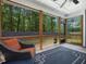 This screened in porch features a ceiling fan and wooded view at 128 Chapel Run Way, Chapel Hill, NC 27517