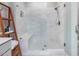 Contemporary shower with marble-look tile, built-in bench, and glass enclosure, creating a luxurious spa experience at 128 Chapel Run Way, Chapel Hill, NC 27517
