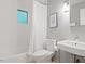 Bathroom with white tiled walls, bathtub with shower, and a modern sink at 1403 Meadow Ln, Chapel Hill, NC 27516