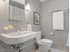 Modern bathroom featuring sleek fixtures, a pedestal sink, and a minimalist design at 1403 Meadow Ln, Chapel Hill, NC 27516