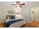 Cozy bedroom features wood-look flooring, a ceiling fan, and comfortable decor at 1403 Meadow Ln, Chapel Hill, NC 27516