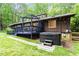 Backyard view of the property with a blue deck and a hot tub at 1403 Meadow Ln, Chapel Hill, NC 27516