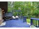 Backyard blue deck with outdoor furniture including a grill and table with chairs at 1403 Meadow Ln, Chapel Hill, NC 27516