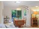 Dining area with natural light, showcasing wood table, hardwood floors and stylish decor at 1403 Meadow Ln, Chapel Hill, NC 27516