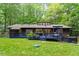 Backyard view of the property with a hot tub and a blue deck at 1403 Meadow Ln, Chapel Hill, NC 27516