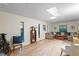 Living room with a skylight, wood-look floors, and large windows at 1403 Meadow Ln, Chapel Hill, NC 27516