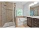Primary bathroom featuring separate shower, tub, and double vanity with tile flooring at 1434 Salem Dr, Apex, NC 27502