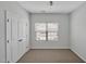 Secondary bedroom with standard carpet, closet, and large window at 1434 Salem Dr, Apex, NC 27502