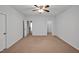 Neutral bedroom with standard carpet and open doors to ensuite bath and walk-in closet at 1434 Salem Dr, Apex, NC 27502