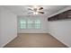 Bedroom featuring ceiling fan, built-in storage and three windows at 1434 Salem Dr, Apex, NC 27502
