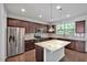 Stylish kitchen with granite island, stainless appliances, dark cabinets, and hardwood floors at 1434 Salem Dr, Apex, NC 27502