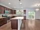 Open kitchen featuring a granite island, stainless steel appliances, and sliding door to a deck at 1434 Salem Dr, Apex, NC 27502