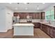 Bright kitchen with a granite island, stainless steel appliances, and wood cabinets at 1434 Salem Dr, Apex, NC 27502