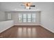 Well-lit living area with hardwood floors, large windows, and neutral walls at 1434 Salem Dr, Apex, NC 27502