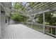 A pergola-covered back deck offers peaceful views of the backyard at 1500 Laureldale Dr, Raleigh, NC 27609