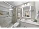 Updated bathroom features a glass-enclosed shower, a vanity, and neutral finishes at 1500 Laureldale Dr, Raleigh, NC 27609