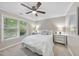 Well lit bedroom with ceiling fan, neutral colors, and a window with natural light at 1500 Laureldale Dr, Raleigh, NC 27609