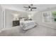 A bright bedroom showcases neutral walls, carpet, and a comfortably made bed by a window at 1500 Laureldale Dr, Raleigh, NC 27609
