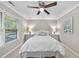 Bedroom with a ceiling fan, neutral colors, and a window that provides plenty of natural light at 1500 Laureldale Dr, Raleigh, NC 27609