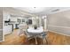 Dining area connected to a white kitchen featuring modern appliances and ample storage at 1500 Laureldale Dr, Raleigh, NC 27609