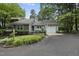 View of this charming house showcasing its well-maintained lawn, landscaping, and private driveway at 1500 Laureldale Dr, Raleigh, NC 27609