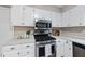 Well-equipped kitchen with stainless steel appliances and white cabinetry at 1500 Laureldale Dr, Raleigh, NC 27609