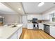 Kitchen with stainless steel appliances, white cabinets and hardwood floors at 1500 Laureldale Dr, Raleigh, NC 27609