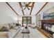 Spacious living room with exposed beams, a fireplace, and a sliding glass door at 1500 Laureldale Dr, Raleigh, NC 27609