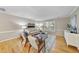 Bright living room featuring hardwood floors, neutral tones, a large window, and stylish furniture at 1500 Laureldale Dr, Raleigh, NC 27609