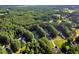 Expansive wooded community showcases cozy single-story homes nestled among tall trees, offering a serene living environment at 1515 Bradsher Dr, Stem, NC 27581
