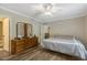 This bedroom features a ceiling fan, wood-look flooring, and neutral paint at 1515 Bradsher Dr, Stem, NC 27581
