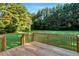 Inviting wooden deck overlooking a sprawling, green backyard, offering a tranquil space for outdoor enjoyment at 1515 Bradsher Dr, Stem, NC 27581