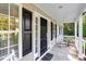 Inviting front porch with a rocking chair and lovely landscaping at 1515 Bradsher Dr, Stem, NC 27581