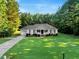 Charming single-story home features a well-manicured lawn and tidy landscaping, complemented by a long driveway at 1515 Bradsher Dr, Stem, NC 27581