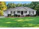 Charming single-story home with a manicured lawn, tidy landscaping, and an attached two-car garage at 1515 Bradsher Dr, Stem, NC 27581