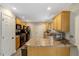 Functional kitchen featuring wooden cabinetry and black appliances at 1515 Bradsher Dr, Stem, NC 27581