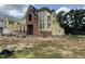 New construction home with large windows and a brick facade under construction in a spacious lot at 1531 Salem Church Rd, Apex, NC 27523