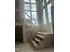 Unfinished staircase is positioned by an oversized window, providing natural light to a modern home at 1531 Salem Church Rd, Apex, NC 27523