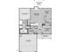Layout of the first floor features primary bedroom, open living area, kitchen, and two-car garage at 20 Malbec Way, Youngsville, NC 27596