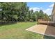 Large backyard featuring a wooden deck, flat grassy areas, and gravel at 21 Cambridge Dr, Angier, NC 27501
