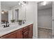 Bathroom featuring double sink vanity with granite countertops, modern fixtures and walk in closet at 21 Cambridge Dr, Angier, NC 27501