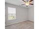 Cozy bedroom featuring a ceiling fan, a window for natural light and comfortable carpet at 21 Cambridge Dr, Angier, NC 27501